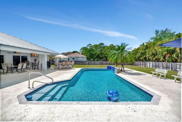 a view of a swimming pool with lounge chair