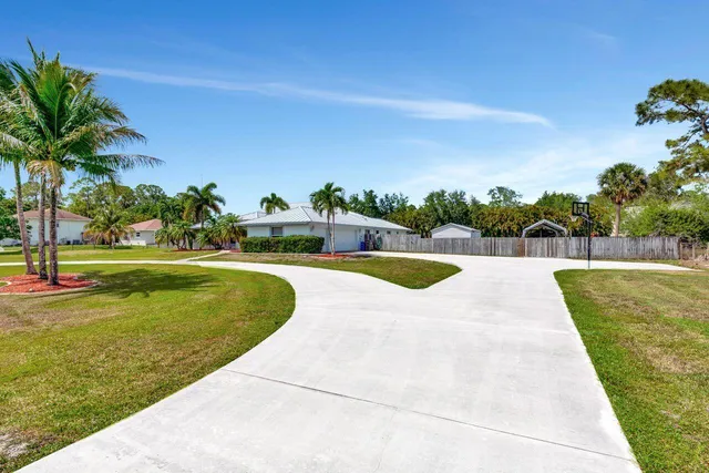a view of a swimming pool and a yard