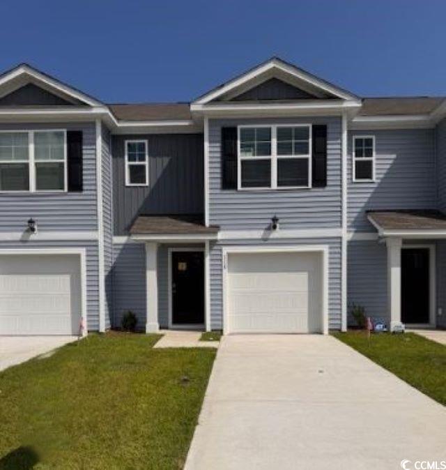 View of front of home with driveway, an attached g