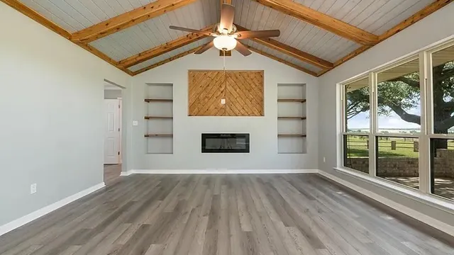wooden floor in an empty room with a window