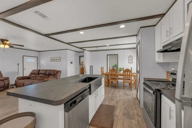 a kitchen with granite countertop a stove and a refrigerator