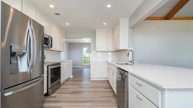 a kitchen with a sink stainless steel appliances and cabinets