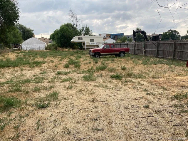 a view of house with outdoor space and car parked