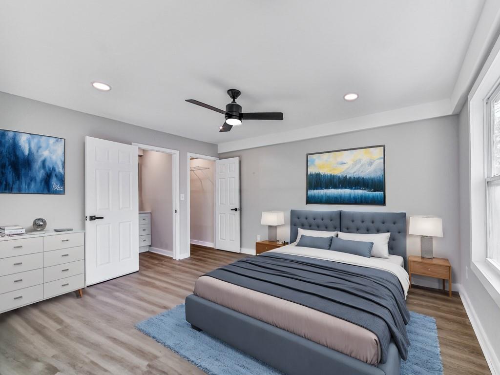 5205 Silhouette Lane Southwest Mableton, GA 30126 - Photo 17 of 21 a bedroom with a large bed and a chandelier