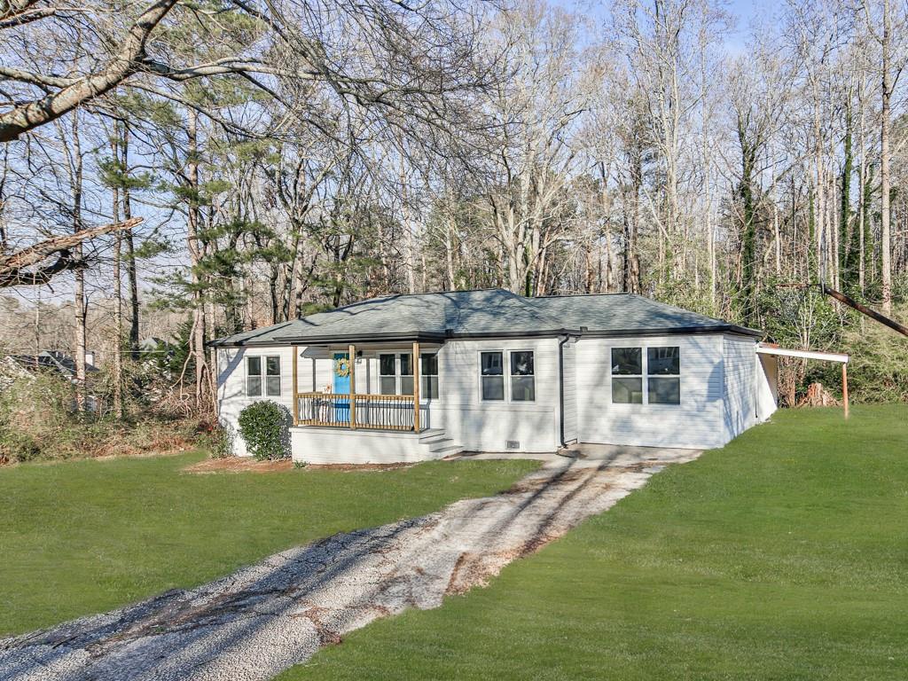 5205 Silhouette Lane Southwest Mableton, GA 30126 - Photo 2 of 21 a front view of a house with a garden and trees