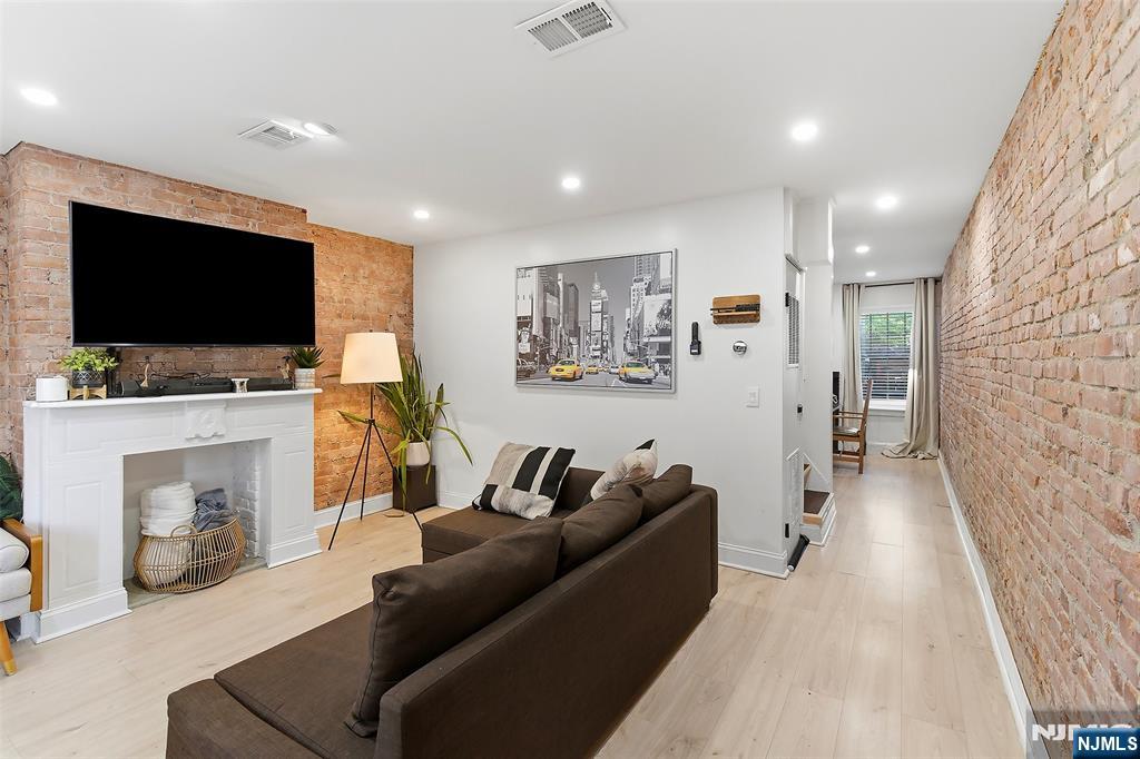 22 8th Avenue Newark, NJ 07104 - Photo 4 of 26 a living room with furniture and a flat screen tv