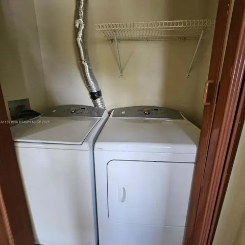 a view of a yard with wooden fence