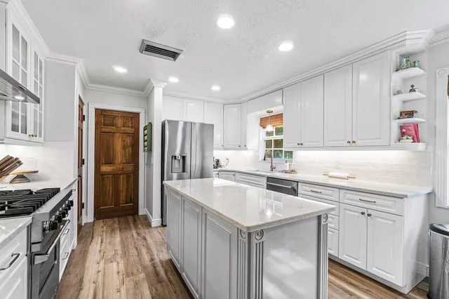 a kitchen with a sink stove and refrigerator