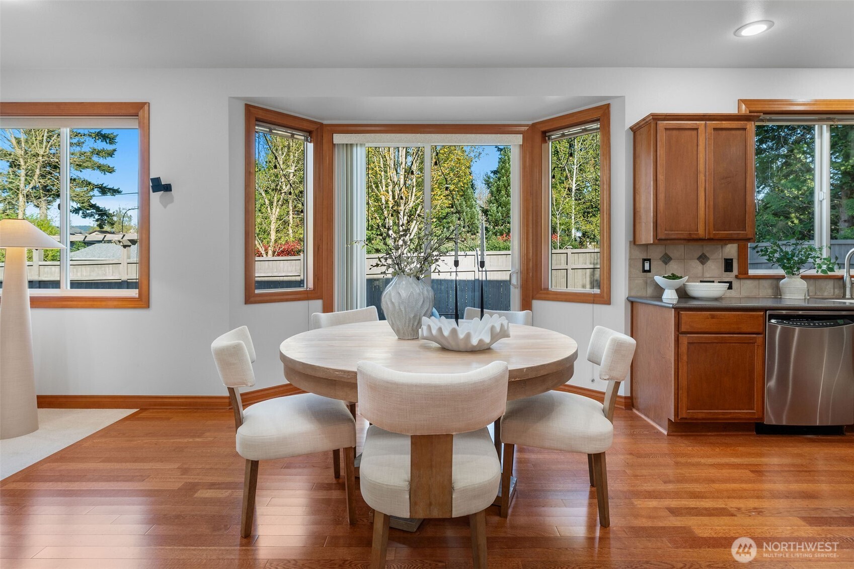 202 Chelan Court Northeast Renton, WA 98059 - Photo 12 of 40 a view of a dining room with furniture window and wooden floor