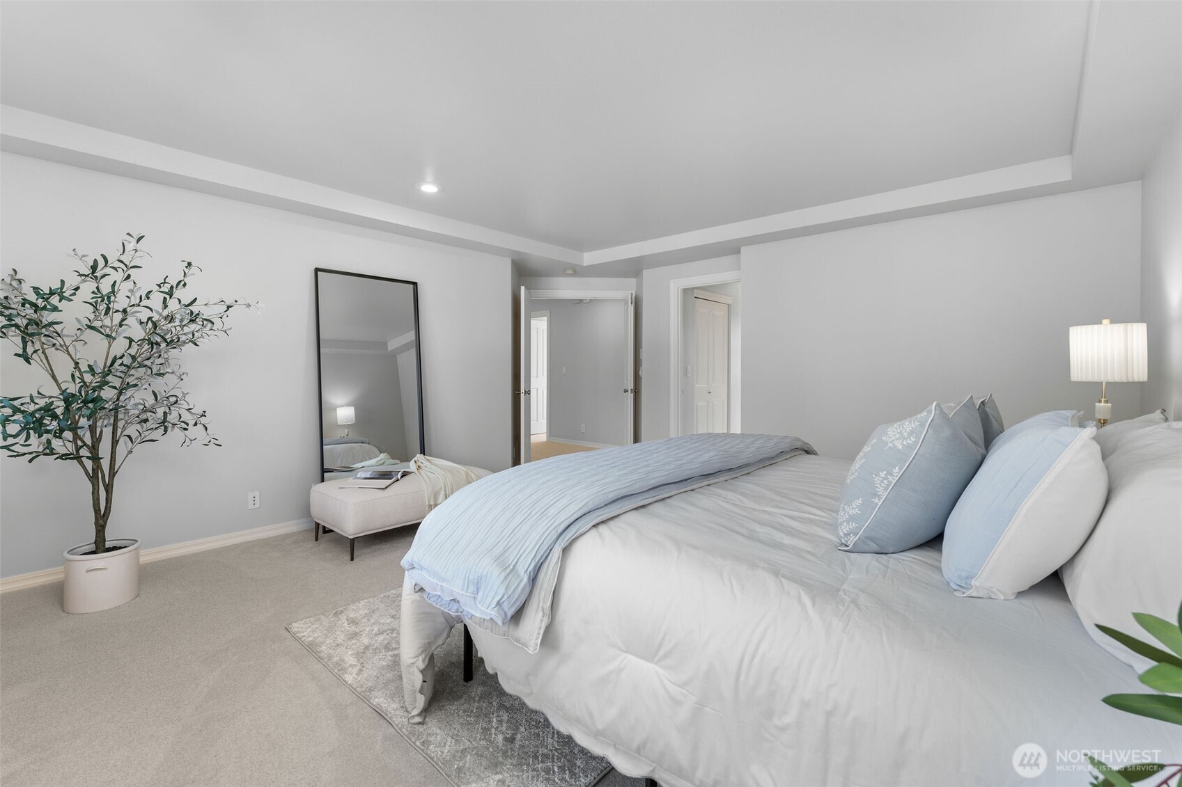 202 Chelan Court Northeast Renton, WA 98059 - Photo 21 of 40 a spacious bedroom with a bed and a potted plant
