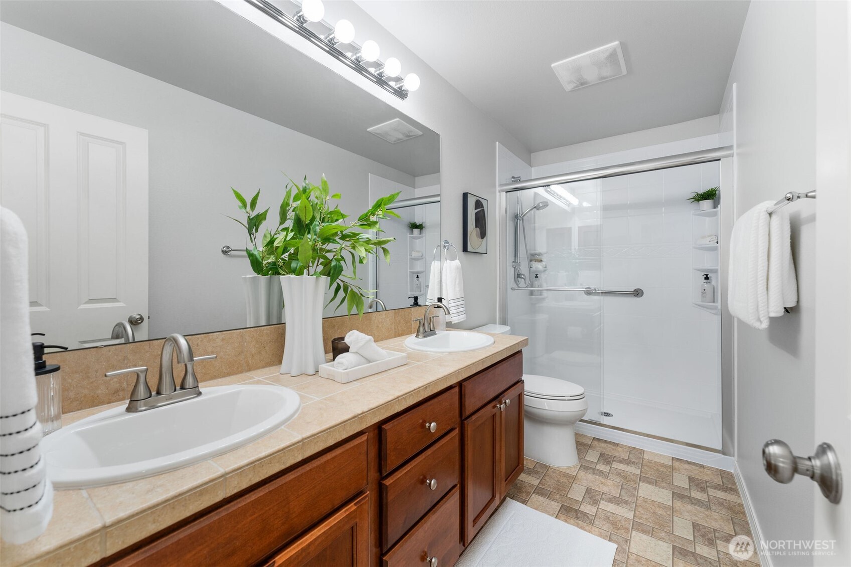 202 Chelan Court Northeast Renton, WA 98059 - Photo 27 of 40 a bathroom with a double vanity sink toilet and shower