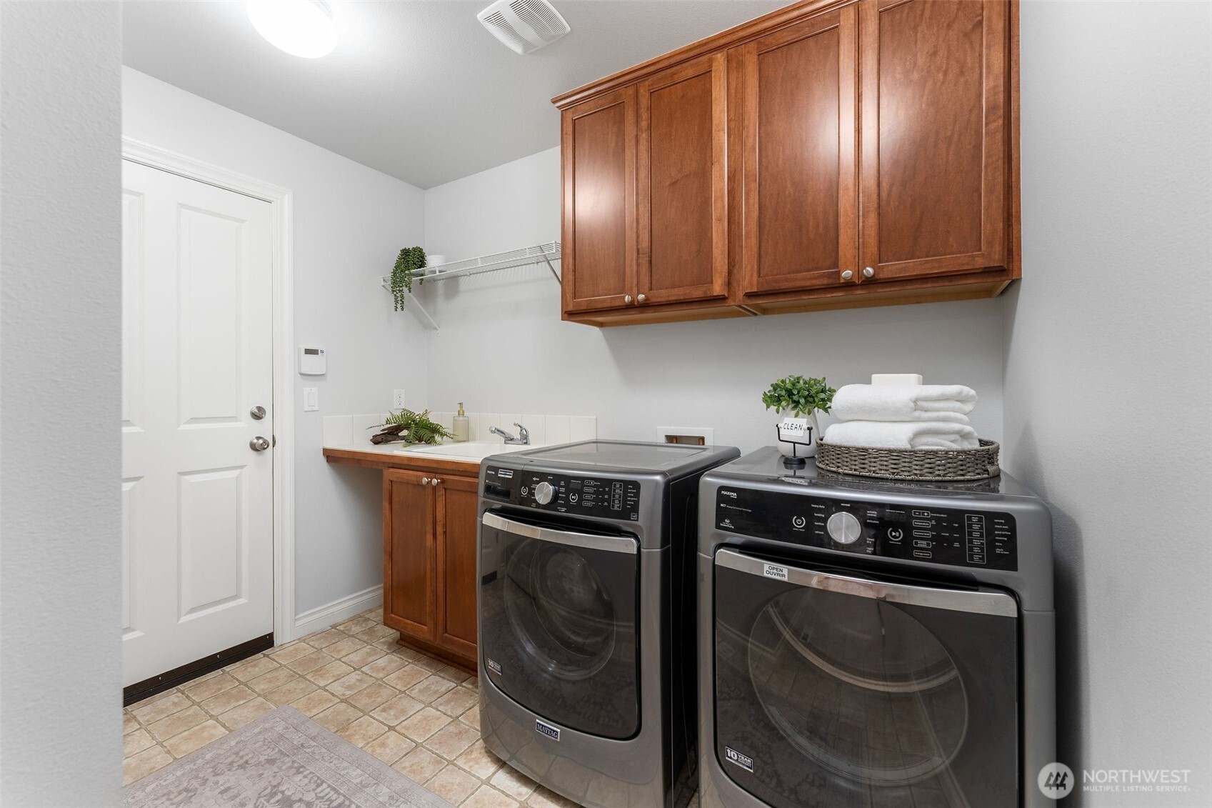 202 Chelan Court Northeast Renton, WA 98059 - Photo 29 of 40 a view of washer and dryer with kitchen countertops
