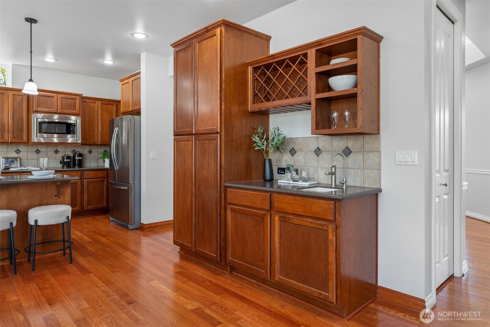 202 Chelan Court Northeast Renton, WA 98059 - Photo 10 of 40 a kitchen with stainless steel appliances granite countertop a refrigerator and a stove top oven