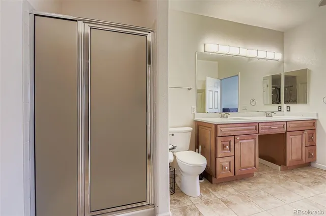a bathroom with a toilet a sink and a mirror