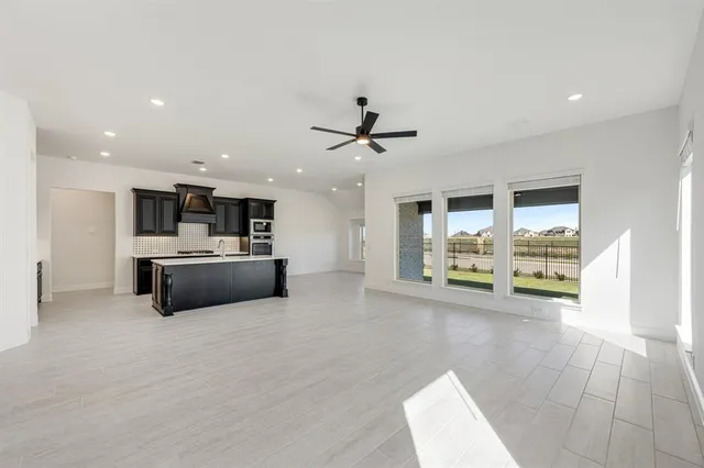 a view of kitchen with furniture and a ceiling fan
