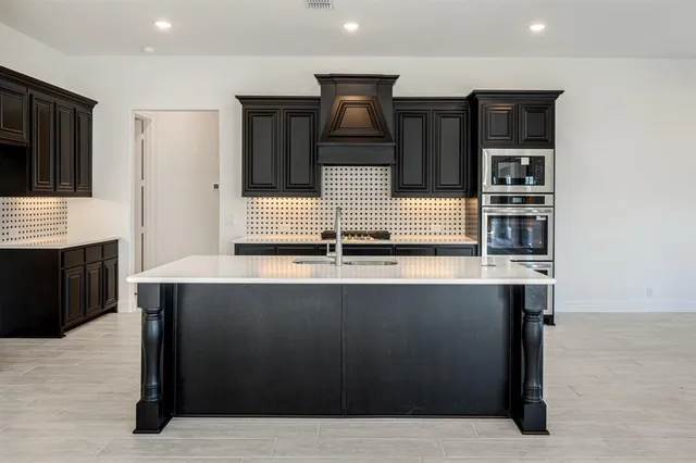 a kitchen with stainless steel appliances a sink and stove