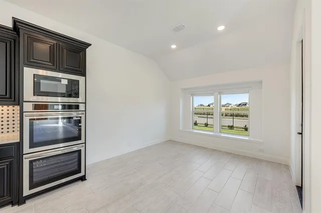 a view of a kitchen with a sink dishwasher and a refrigerator