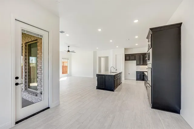 a view of a kitchen with a refrigerator a kitchen a sink and a refrigerator
