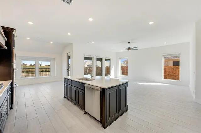 a kitchen with stainless steel appliances granite countertop a stove and a refrigerator