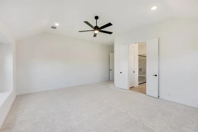 an empty room with closet and windows