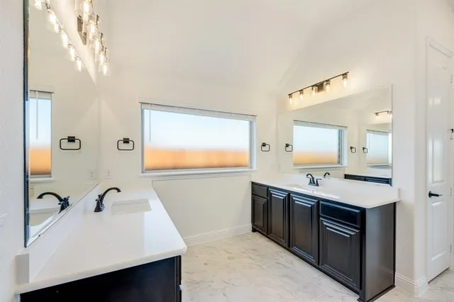 a bathroom with a glass shower door