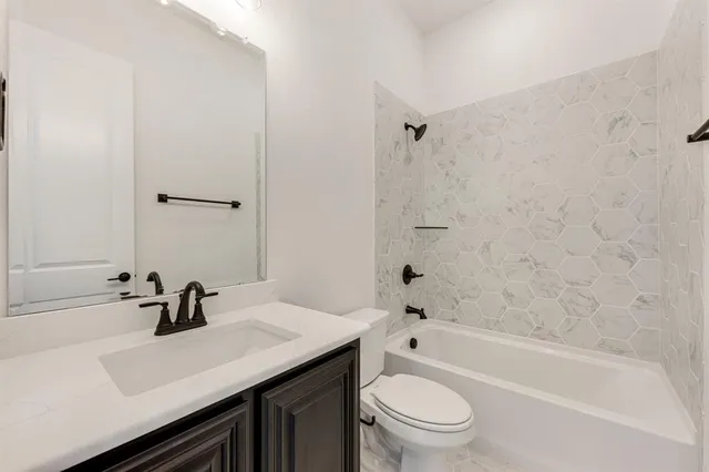 a bathroom with a sink a toilet and a bathtub