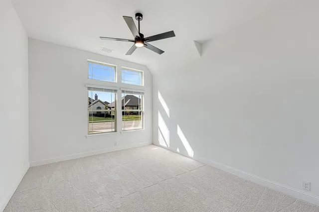 a view of a livingroom with a ceiling fan and window
