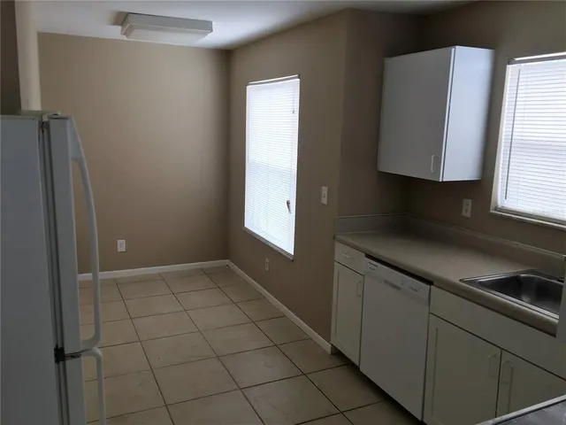 a kitchen with a sink cabinets and a window