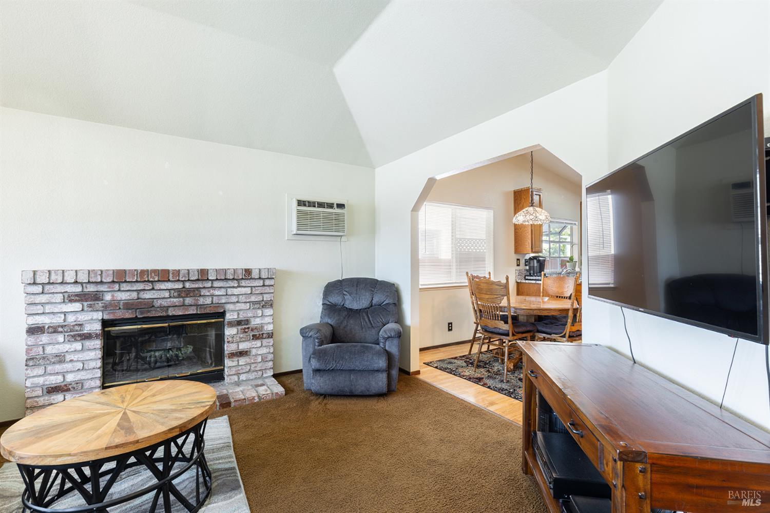 1935 Seville Street Santa Rosa, CA 95403 - Photo 24 of 30 a living room with furniture a flat screen tv and a fireplace