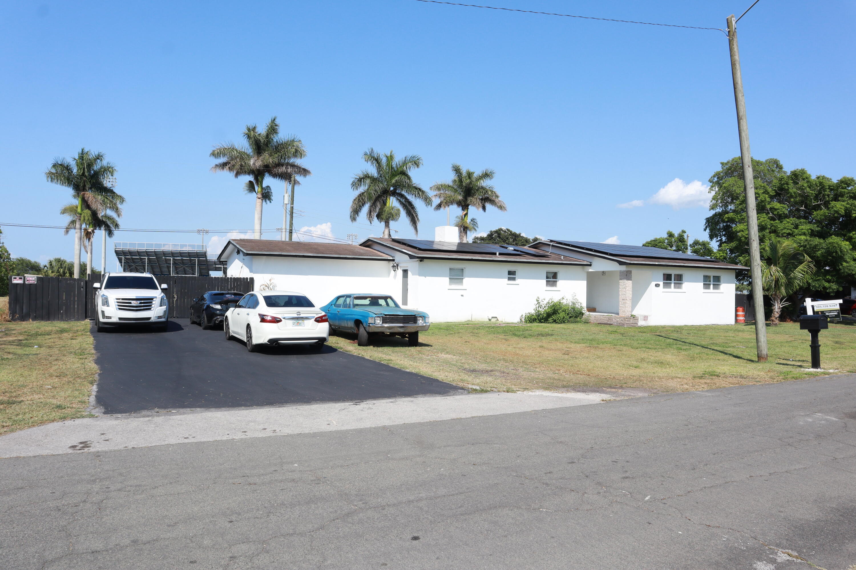 a couple of cars parked in front of a house