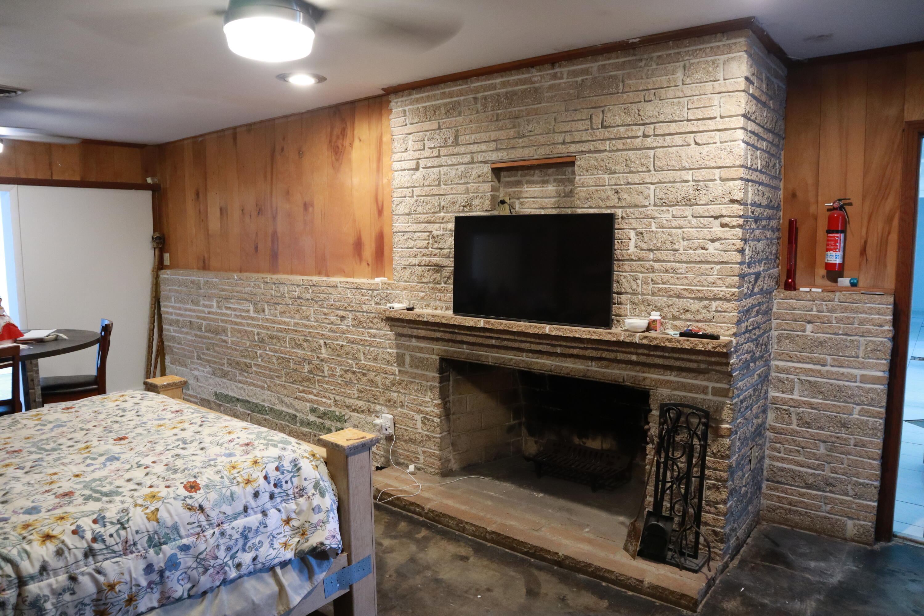 360 Kismet Avenue Pahokee, FL 33476 - Photo 15 of 100 a living room with a fireplace flat screen tv and outdoor view