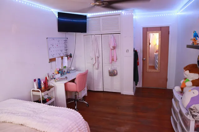 a view of empty room with window and chandelier