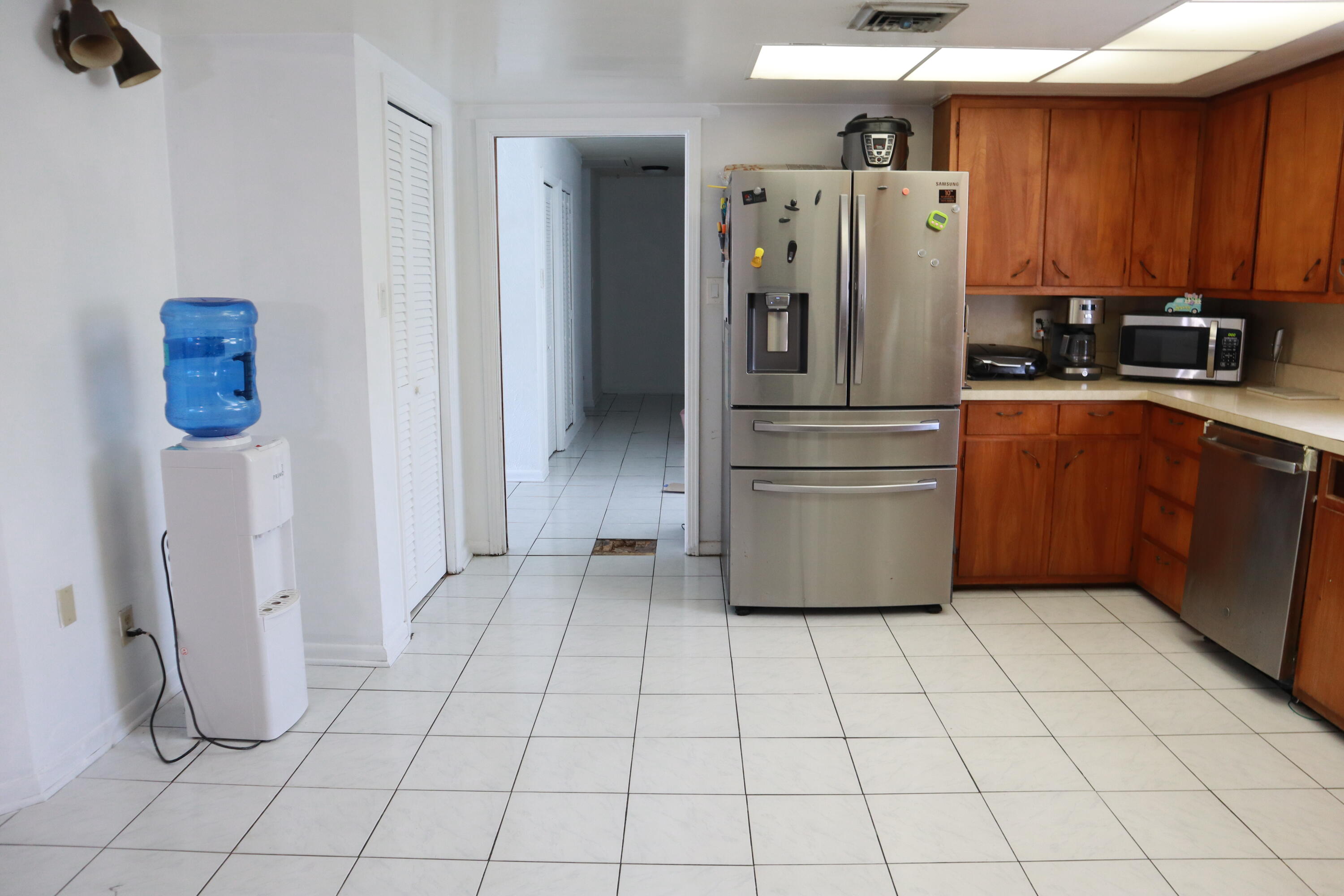 360 Kismet Avenue Pahokee, FL 33476 - Photo 35 of 100 a kitchen with stainless steel appliances a refrigerator sink and cabinets