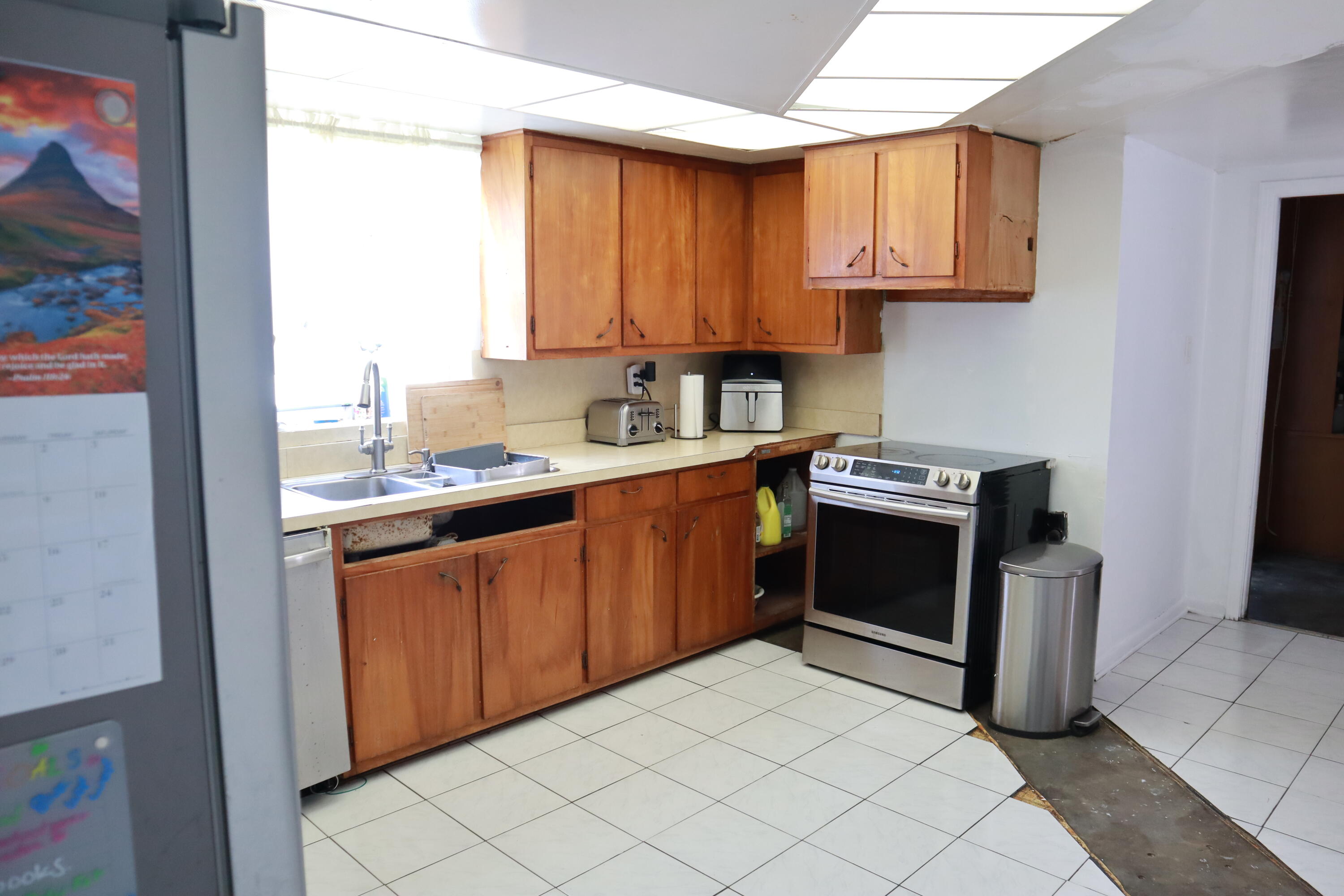 360 Kismet Avenue Pahokee, FL 33476 - Photo 37 of 100 a kitchen with stainless steel appliances granite countertop a stove a sink and a refrigerator
