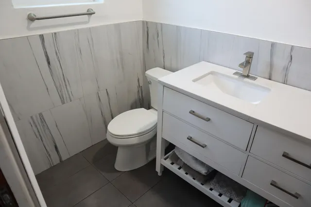 a view of a house with backyard sitting area and swimming pool