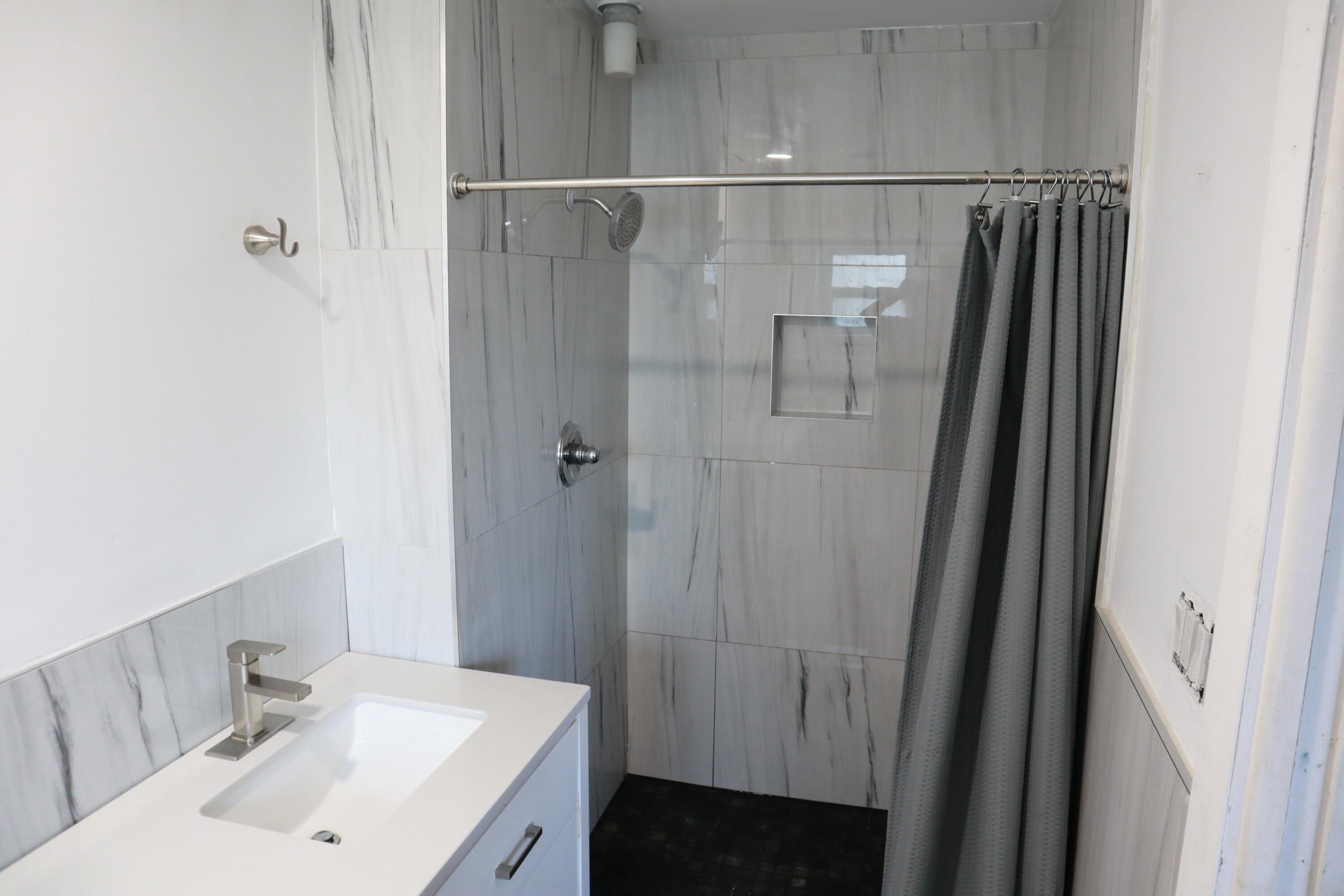 360 Kismet Avenue Pahokee, FL 33476 - Photo 42 of 100 a bathroom with a sink toilet and shower