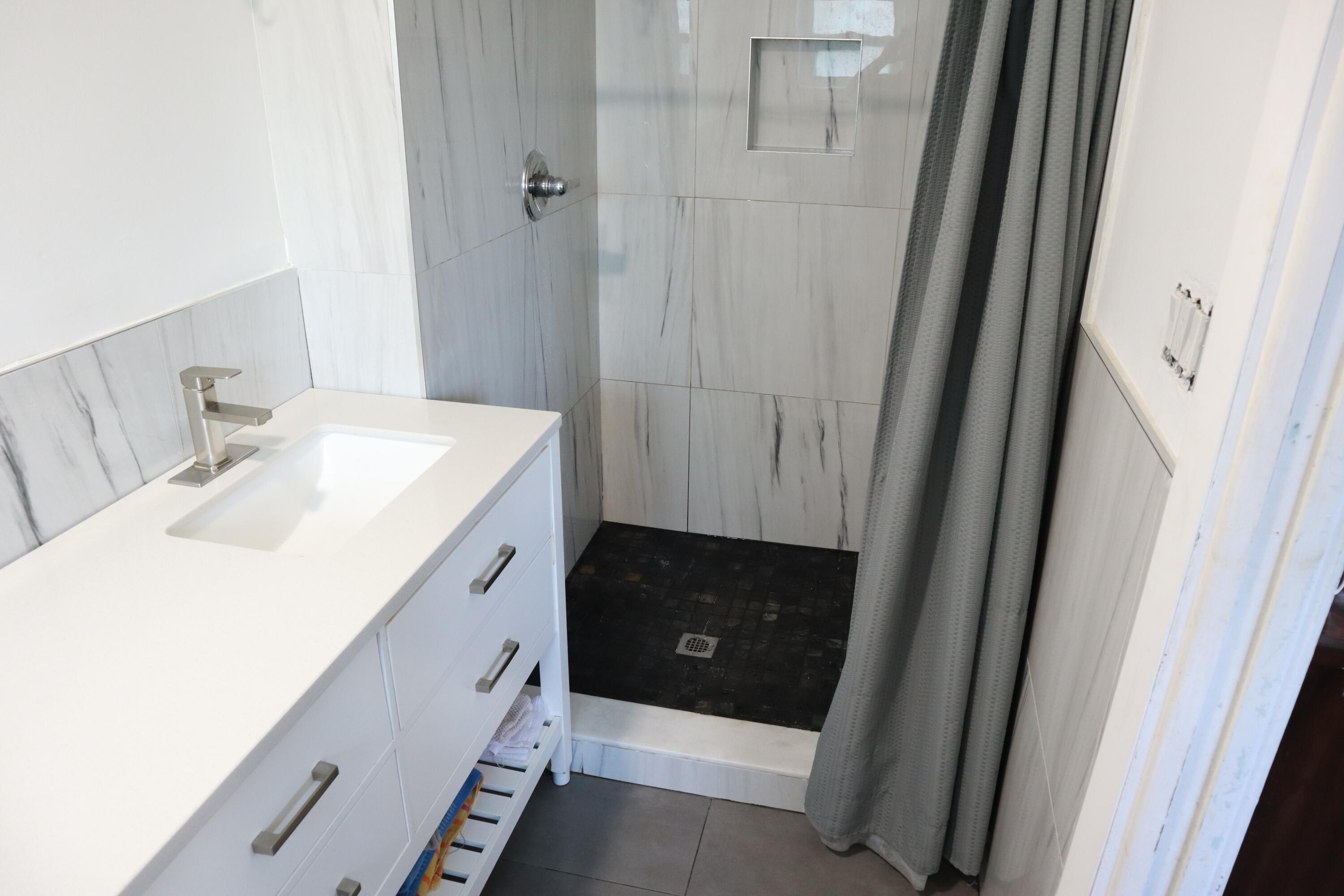 360 Kismet Avenue Pahokee, FL 33476 - Photo 43 of 100 a bathroom with a double vanity sink and mirror