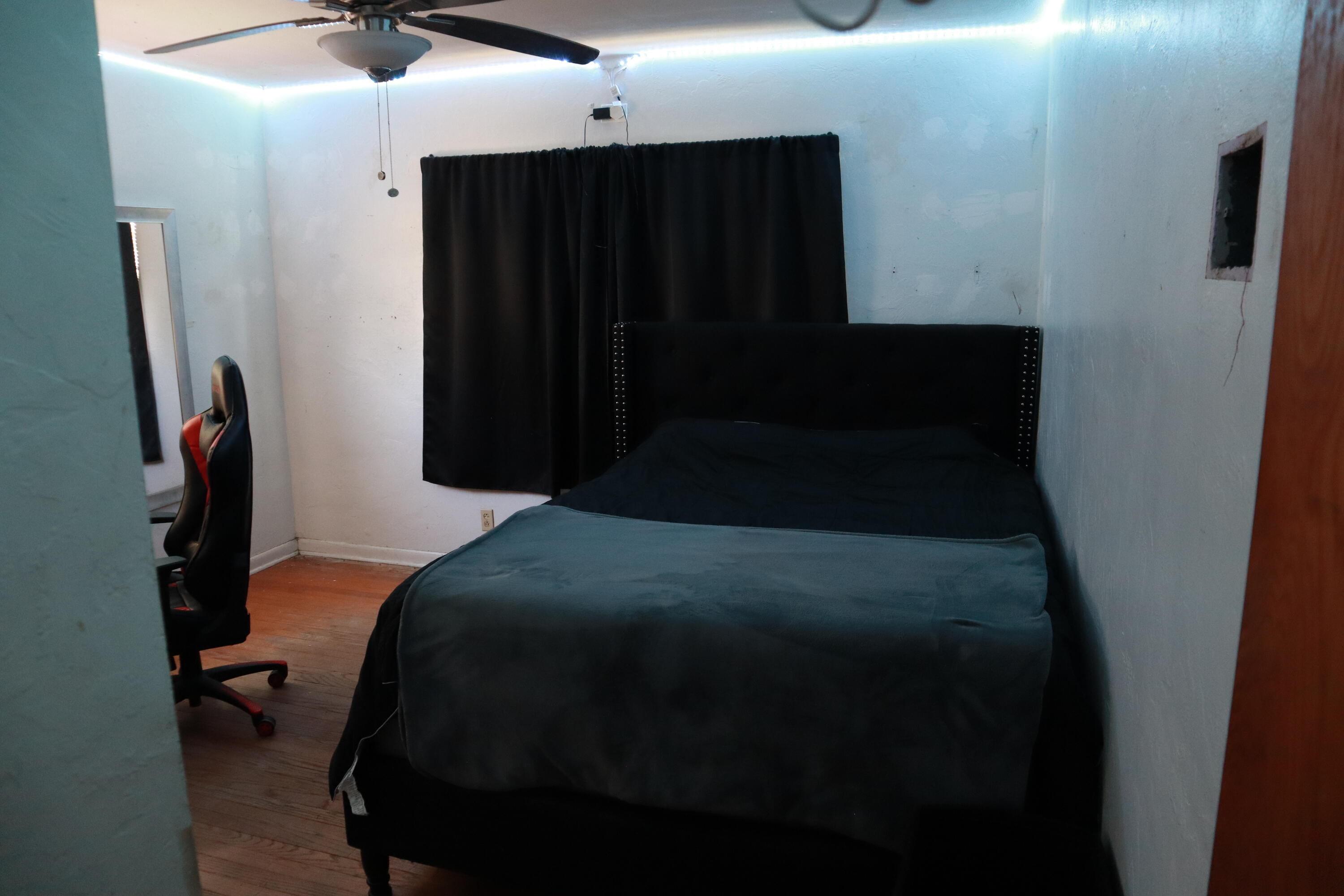 360 Kismet Avenue Pahokee, FL 33476 - Photo 46 of 100 a bedroom with a bed and a chandelier