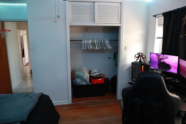 a view of a swimming pool with a lawn chairs under an umbrella