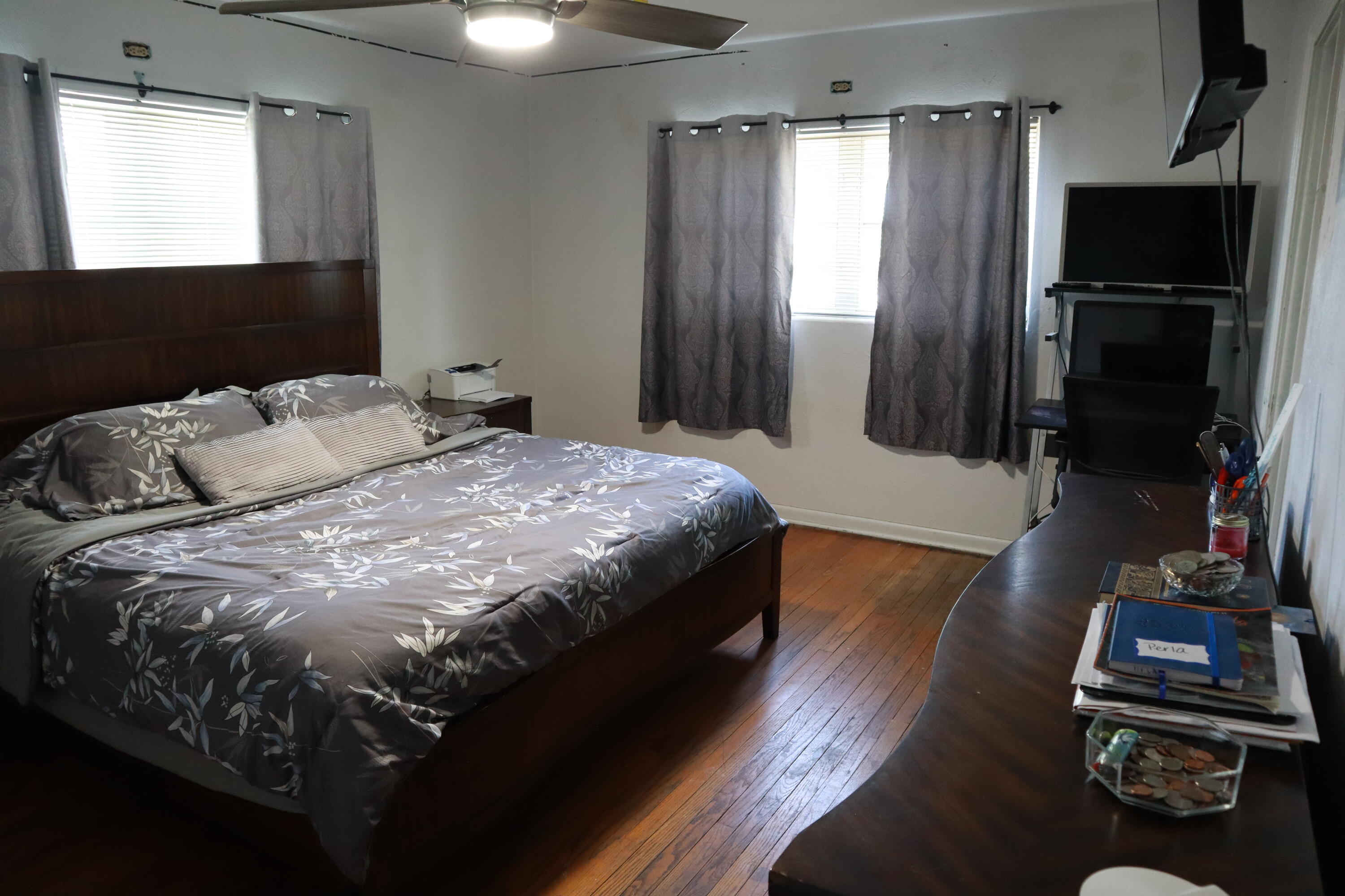 360 Kismet Avenue Pahokee, FL 33476 - Photo 54 of 100 a bedroom with a bed and a flat tv screen on a dresser