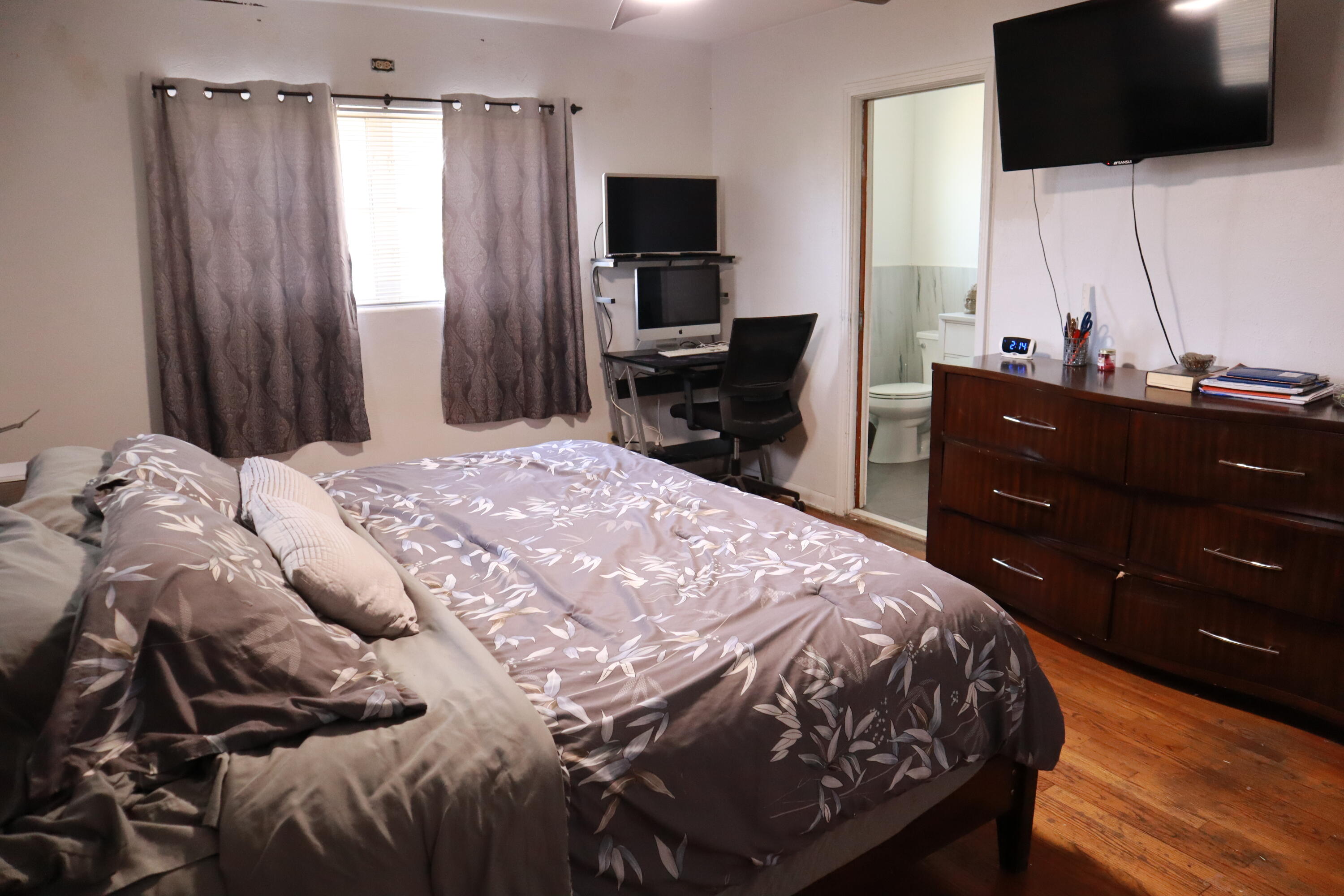 360 Kismet Avenue Pahokee, FL 33476 - Photo 55 of 100 a bedroom with a bed and a flat tv screen on dresser