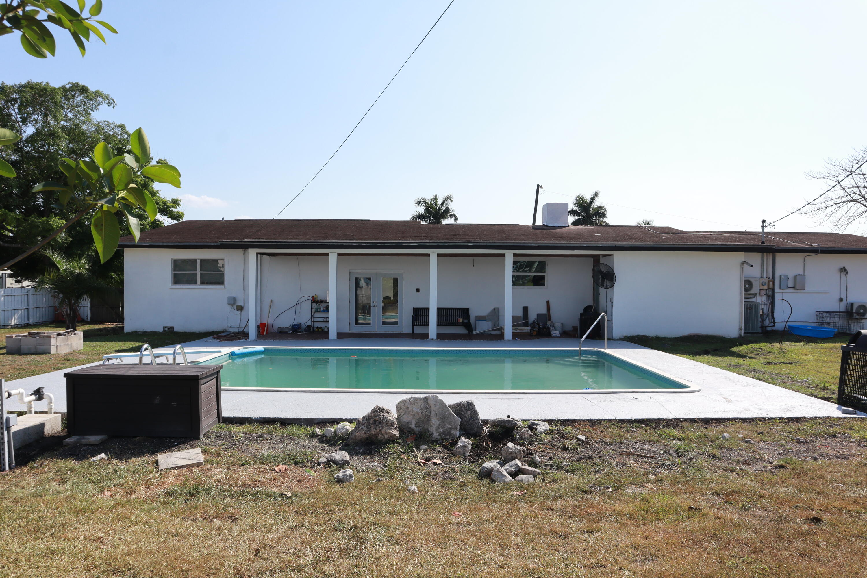 360 Kismet Avenue Pahokee, FL 33476 - Photo 75 of 100 a view of a house with backyard sitting area and swimming pool