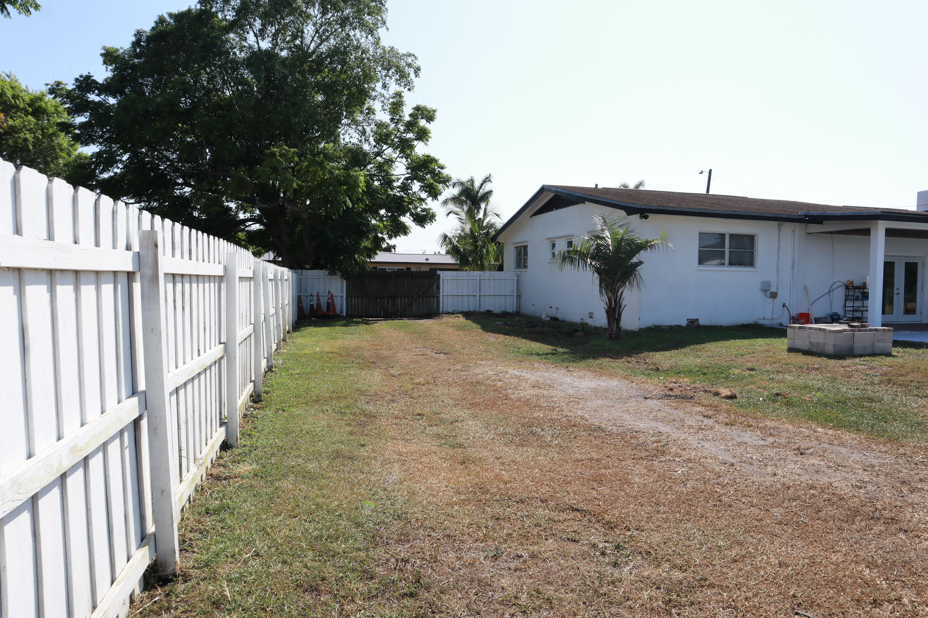 360 Kismet Avenue Pahokee, FL 33476 - Photo 77 of 100 a view of a house with backyard and tree