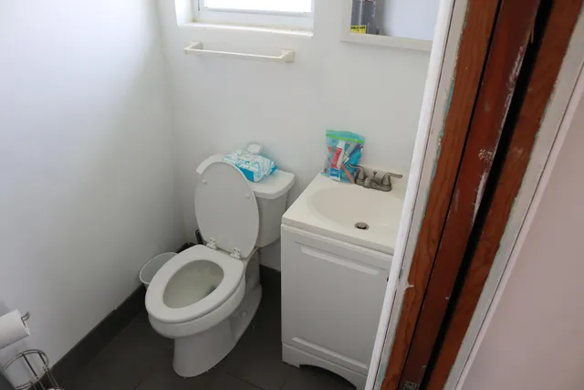 a bed room with a bed and a chair