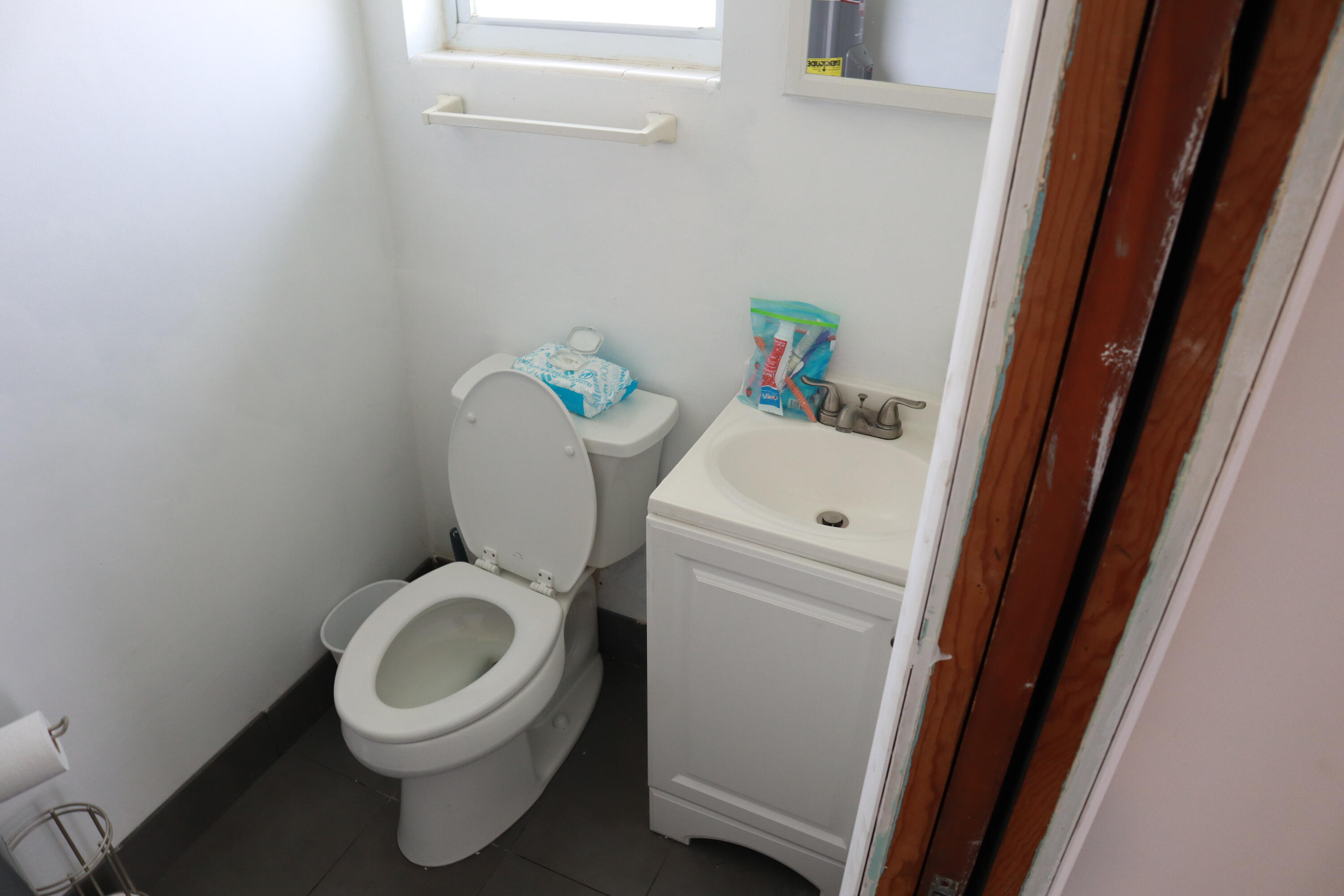 360 Kismet Avenue Pahokee, FL 33476 - Photo 8 of 100 a white toilet sitting next to a sink