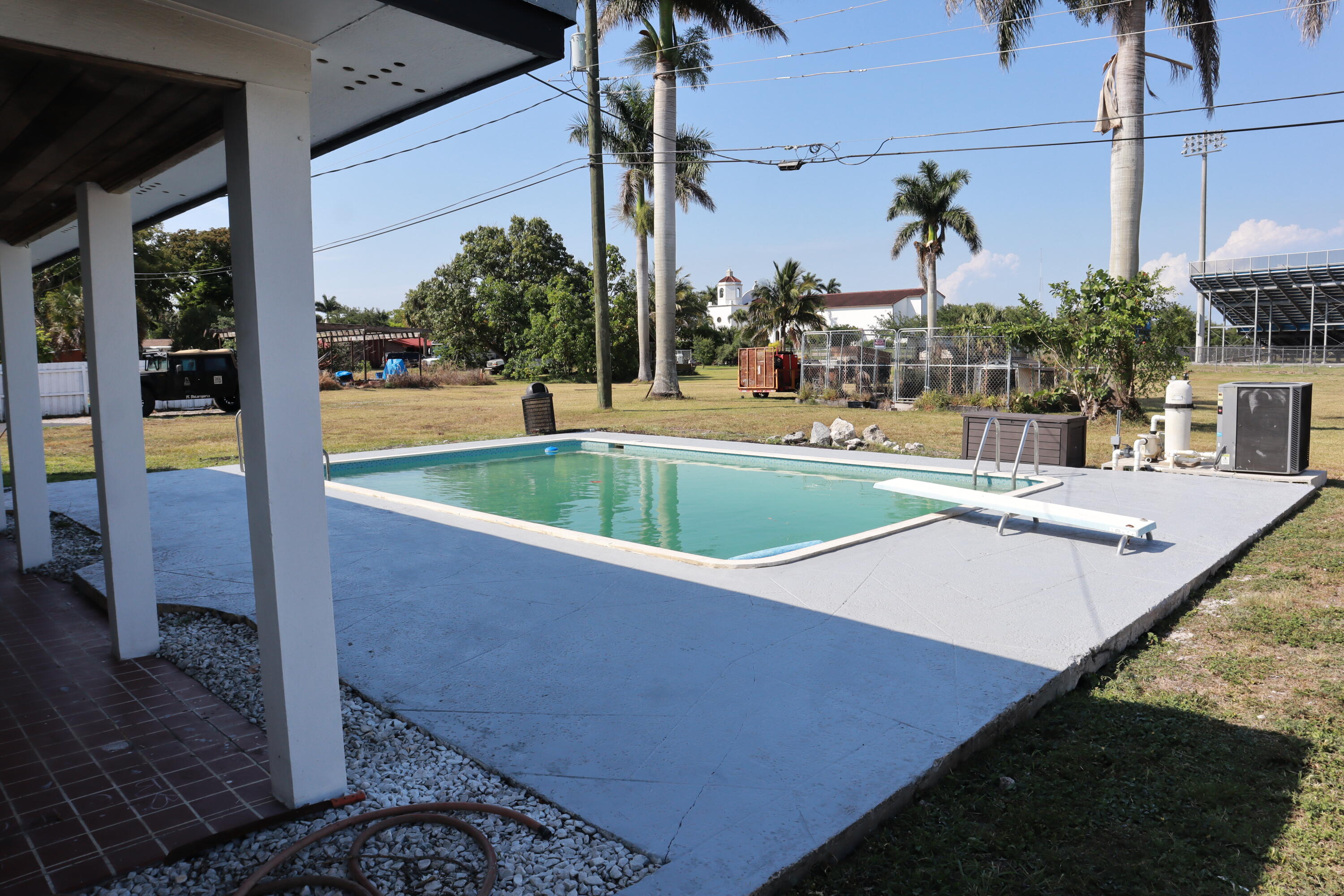 360 Kismet Avenue Pahokee, FL 33476 - Photo 81 of 100 a view of a swimming pool with a patio