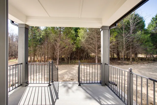 a view of a room with wooden floor and iron stairs