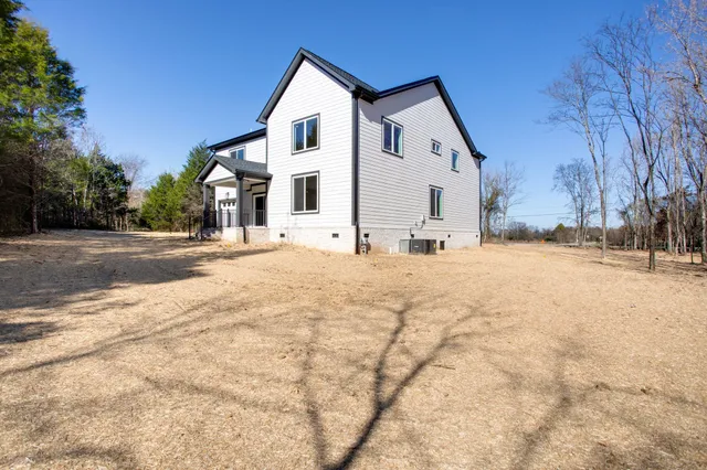 a view of a house with snow on the road