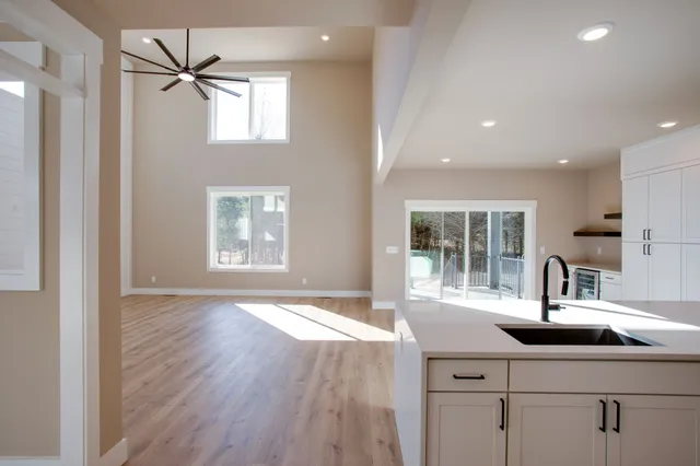 a kitchen with a sink and wooden floor