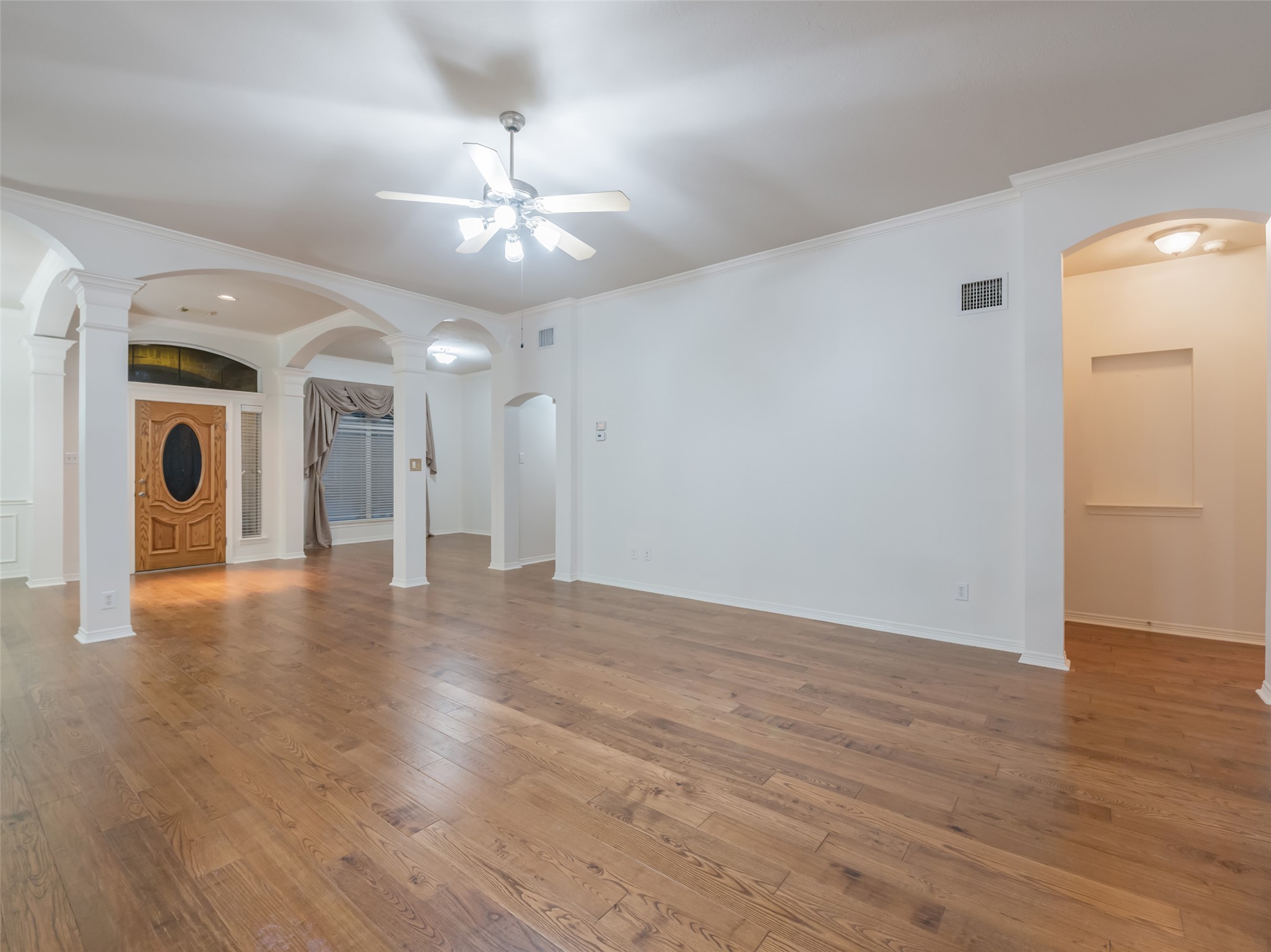1511 Baldridge Lane Katy, TX 77494 - Photo 16 of 50 a view of a hallway with wooden floor and a chandelier